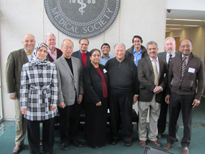 An image of the IMG members group standing in front a Michigan State Medical Society seal