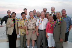 The MSMS Organized Medical Staff Section members standing together as a group on a boat with a sunny horizon behind them