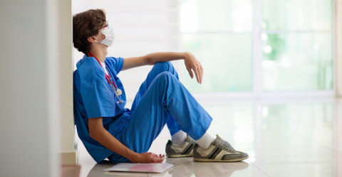 tired doctor sitting on the floor
