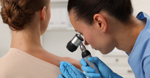 doctor inspecting skin